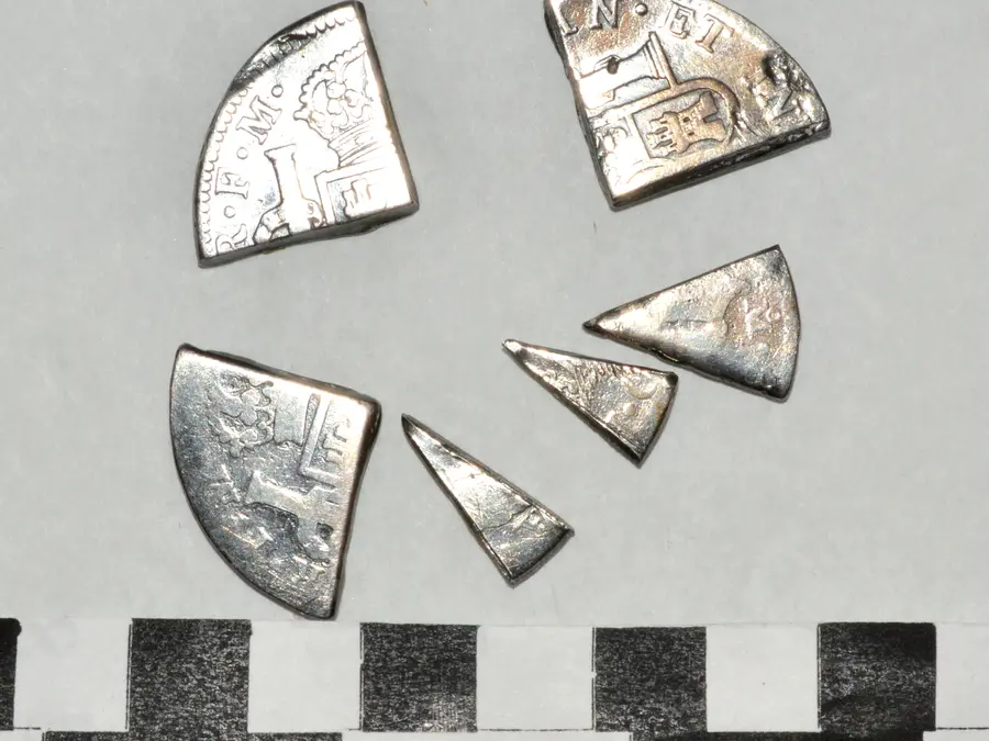 Six wedge-shaped pieces cut from Spanish silver eight-reales coins