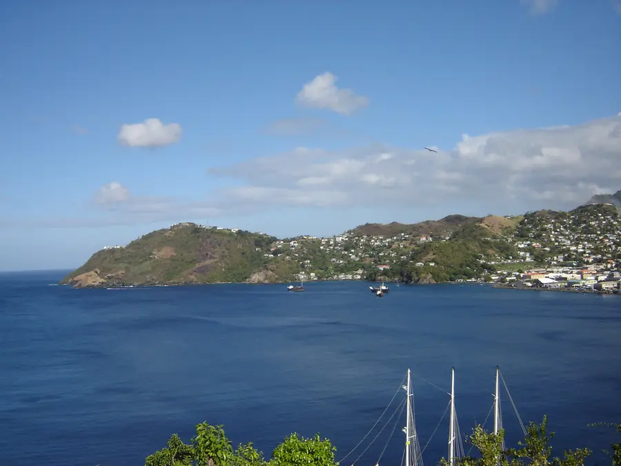 Kingstown Harbour in St Vincent seen from the south, with boats at anchor below green hills